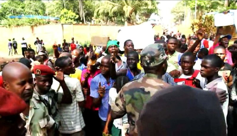 Members of a crowd shout at soldiers during an address by President Francois Bozize in Bangui, Central African Republic, in this frame taken from Associated Press footage from Thursday. 