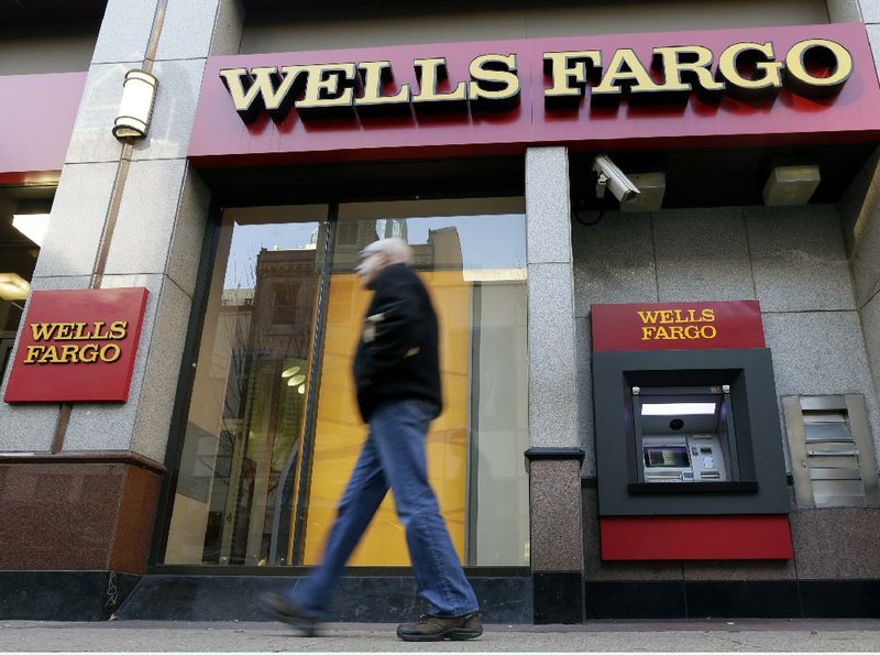 A pedestrian passes a Wells Fargo branch bank in Philadelphia earlier this month. U.S. banks are on pace to end the year with their best proÿts since 2006. 