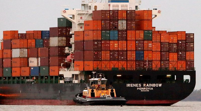 A Monrovian container ship arrives at the Port of New Orleans just before sunrise Friday. A proposed agreement with dockworkers has prevented a major port strike for now. 