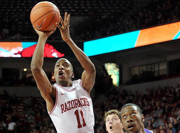 NWA Media/MICHAEL WOODS --12/29/2012-- University of Arkansas guard BJ Young drives to the hoop past Northwestern State forward DeQuan Hicks during the first half of Saturday night's game against the Demons at Bud Walton Arena in Fayetteville.