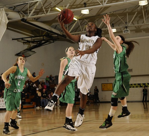 Bentonville’s Jamayne Potts, center, takes the ball to the basket past Pierce City (Mo.) defender Shania Hogan, right, during the Lady Tigers’ game Friday during the Neosho (Mo.) Holiday Classic in Neosho, Mo. 