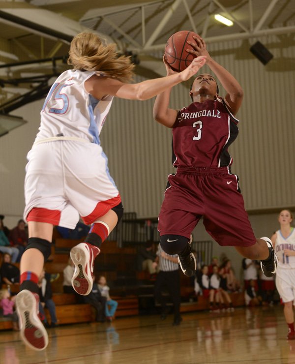 Springdale’s Baiyinnah Taylor, right, makes a shot in front of Webb City (Mo.) defender Mikaela Burgess during the Lady Bulldogs’ game Friday during the Neosho (Mo.) Holiday Classic in Neosho, Mo. 