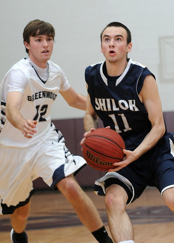 Andrew Daniels, right, of Shiloh Christian School gets past Ryan Davis of Greenwood High School Friday, Dec. 28, 2012, at Siloam Springs High School during round two of the Siloam Springs Holiday Tournament.