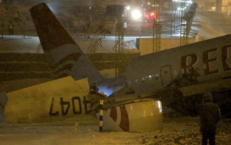 Wreckage of a plane which careered off the runway at Vnukovo Airport in Moscow, Saturday, Dec. 29, 2012. A Tu-204 aircraft belonging to Russian airline Red Wings careered off the runway at Russia's third-busiest airport on Saturday, broke into pieces and caught fire, killing several people.