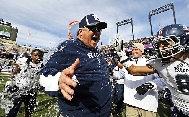 Rice Coach David Bailiff reacts after being drenched with water by players following the Owls’ 33-14 victory over Air Force on Saturday at the Armed Forces Bowl in Fort Worth, Texas. 