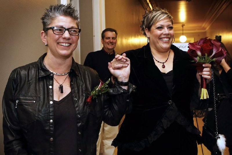 Donna Galluzzo (left) and Lisa Gorney leave the city clerk’s office Saturday after obtaining their marriage license at City Hall in Portland, Maine.

