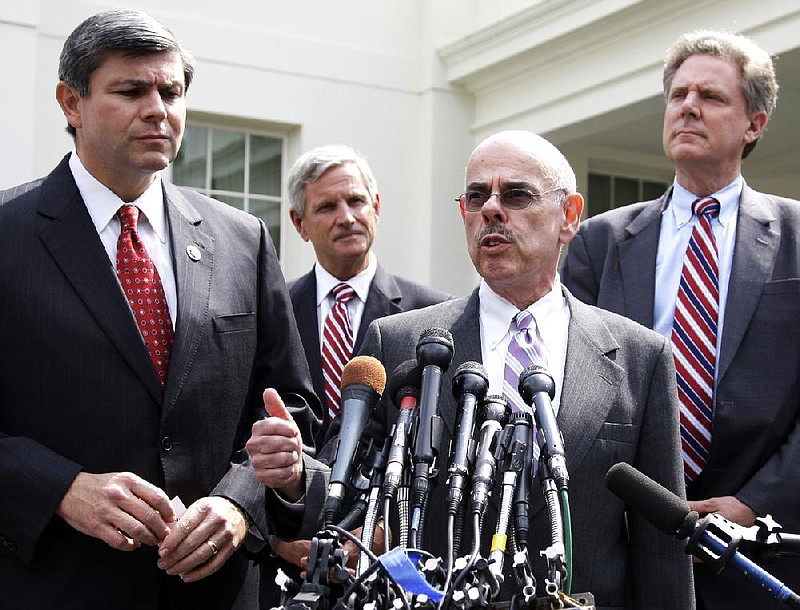 Mike Ross (left) listens to Henry Waxman, along with other House Blue Dog Democrats Baron Hill and Frank Pallone (right), after a meeting on health-care legislation with President Barack Obama on July 21, 2009. 