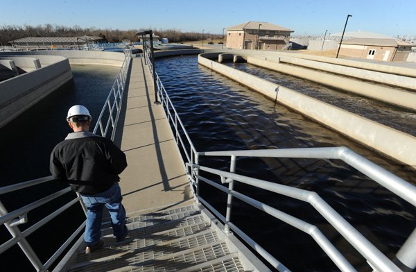 Timothy Tinsley, an operator for CH2M Hill, which operates Fayetteville’s West Side Wastewater Treatment Plant, walks Dec. 13 through the plant. 