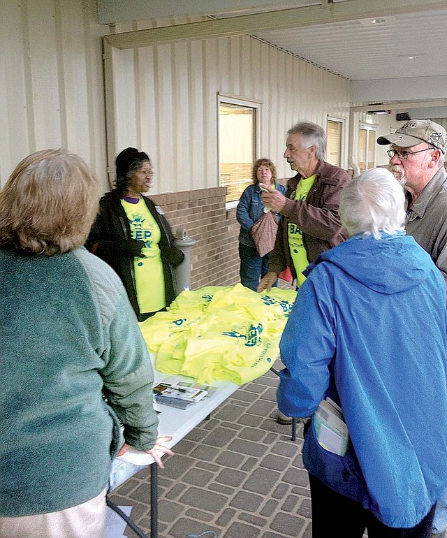 Opponents of uranium mining in Virginia gather outside a Dec. 12 meeting near the proposed mine site, distributing neon yellow T-shirts that say “Keep the Ban.” 