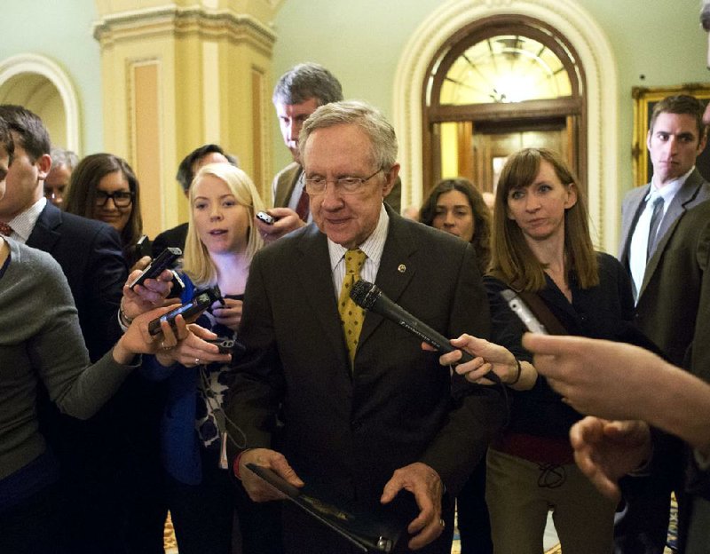 Senate Majority Leader Harry Reid, D-Nev., retreats to a private meeting with fellow Democrats as he and Senate Minority Leader Mitch McConnell, R-Ky., work to avoid the “fiscal cliff” Sunday in Washington. 