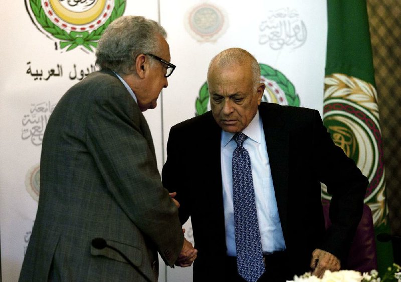 United Nations and Arab League envoy to Syria Lakhdar Brahimi (left) shakes hands with Arab League Secretary-General Nabil Elaraby after a joint news conference Sunday at the Arab League headquarters in Cairo. 