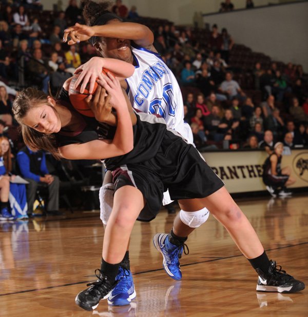 Morgan Miller, left, Siloam Springs junior, and Conway’s Asia Willard vie for a loose ball Saturday during the first half of the championship game of the Siloam Springs Holiday Tournament. 