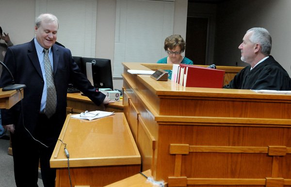 Jeff Harper, left, speaks with Ernest Cate, Springdale District Judge, Friday during Harper’s last day in court. Harper, who has been Springdale’s city attorney for 26 years, will take over as district judge for Cate beginning Jan. 1. 