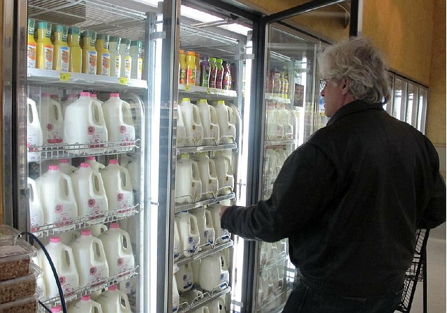 Jim Mitchell selects a gallon of milk at a Milwaukee grocery store in early December. 