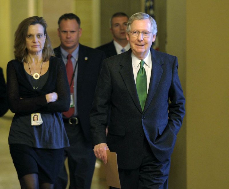 Senate Minority Leader Mitch McConnell, R-Ky., walks toward the Senate floor Monday in Washington. McConnell said he and the White House were close to a deal on preventing tax increases. 