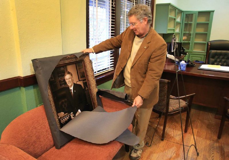 North Little Rock Mayor Patrick Hays unveils his portrait in his office Monday, his last day as mayor. Hays was mayor for 24 years. The portrait, taken by photographer Tim Wooldridge, will hang in City Hall. 