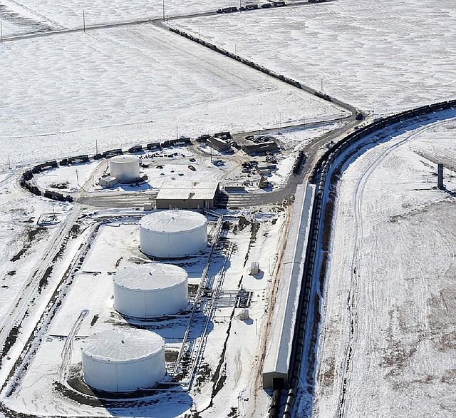 Tractor-trailers line up for two miles in Trenton, N.D., in November as they wait to unload oil to be shipped by rail. 