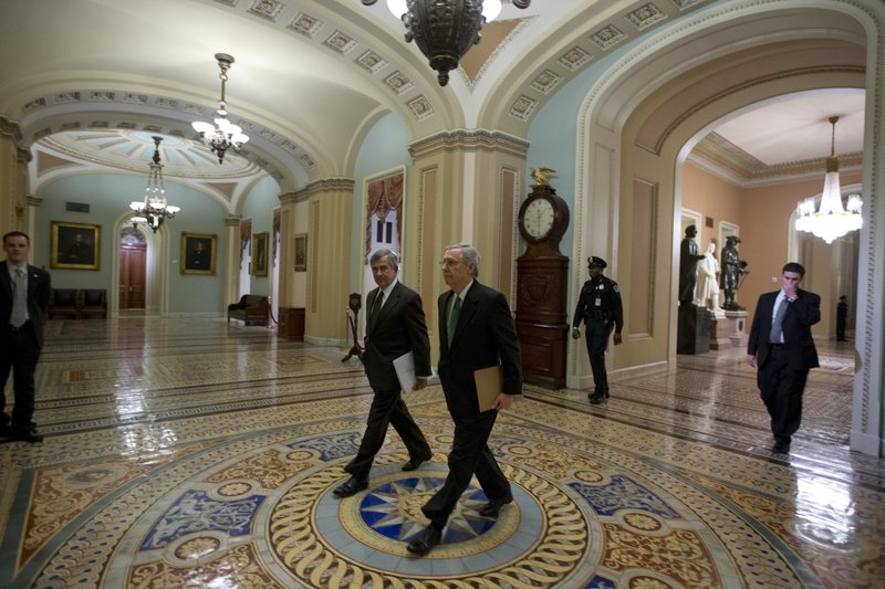 Sen. Mike Johanns, R-Neb., left, walks with Senate Minority Leader Mitch McConnell from Kentucky, to the Senate floor for a vote on the fiscal cliff, on Capitol Hill Tuesday, Jan. 1, 2013 in Washington. The Senate passed legislation early New Year's Day to neutralize a fiscal cliff combination of across-the-board tax increases and spending cuts that kicked in at midnight.