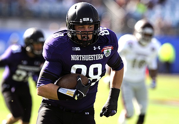 Northwestern defensive lineman Quentin Williams (88) returns a interception for a touchdown during the first half of the Gator Bowl NCAA college football game against Mississippi State, Tuesday, Jan. 1, 2013, in Jacksonville, Fla. (AP Photo/Stephen Morton)