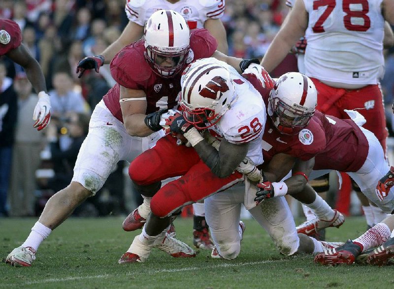 Wisconsin running back Montee Ball (28) tries to break through the Stanford defense in the ÿ rst half of Tuesday’s Rose Bowl. 