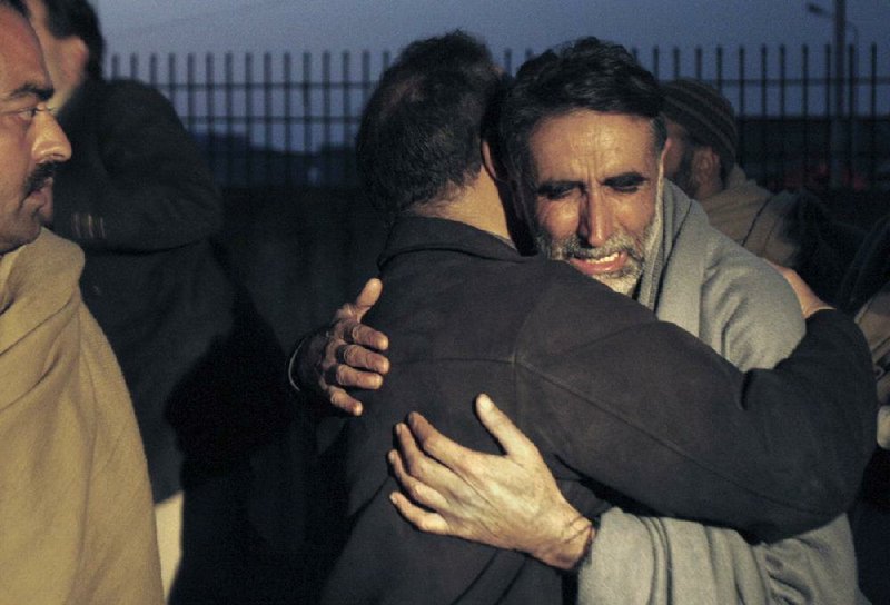 A father of an aid worker, who was killed by gunmen, mourns the death of his daughter at a hospital in Swabi, Pakistan, Tuesday, Jan. 1, 2013. Gunmen in northwest Pakistan killed at least five female teachers and two aid workers on Tuesday in an ambush on a van carrying workers home from their jobs at a community center, officials said. (AP Photo/Mohammad Sajjad)