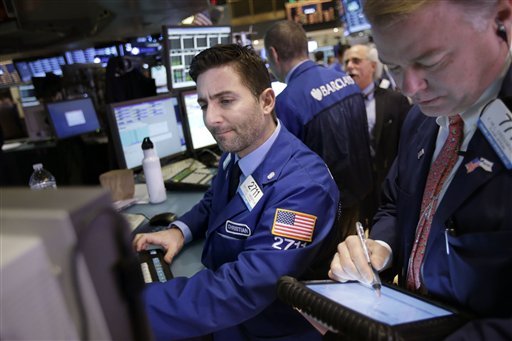 Traders work on the floor at the New York Stock Exchange in New York, Wednesday, Jan. 2, 2013. The “fiscal cliff” compromise, for all its chaos and controversy, was enough to send the stock market shooting higher Wednesday, the first trading day of the new year. 