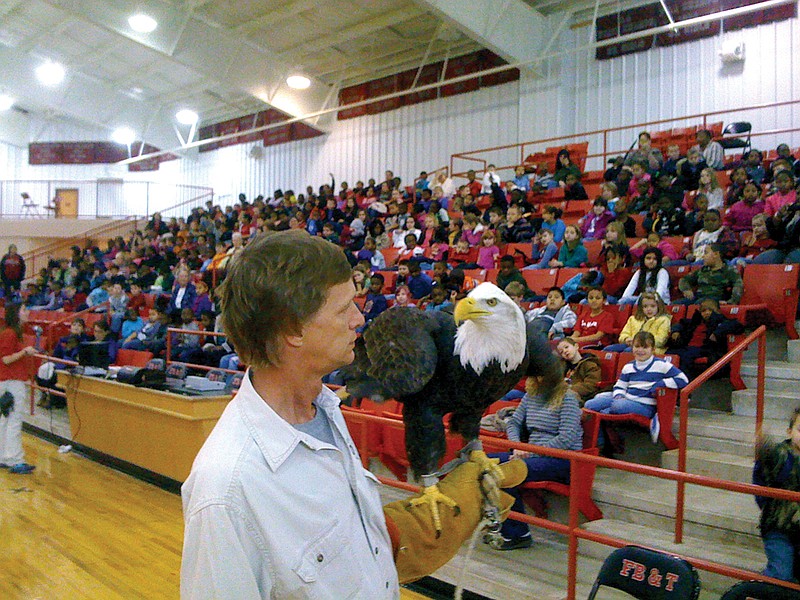 Rodney Paul, a raptor rehabilitation specialist, holds Lynn, an eagle from the Little Rock Zoo, so students can see her during a special birds of prey educational program. The program that features hawks, owls, a falcon and the American Bald Eagle is a joint effort of the Little Rock Zoo and DeGray Lake State Park in Bismarck. Eagles Et Cetera, a festival about birds of prey, will be held at the state park late in January.