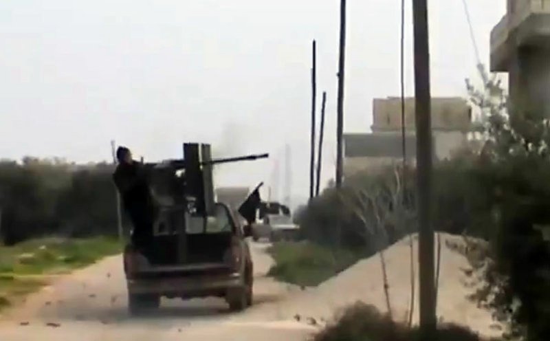 A Free Syrian Army fighter fighter a weapon in Taftanaz village, Idlib province, northern Syria, on Wednesday, Jan. 2, 2013, in this image taken from video obtained from the Shaam News Network, which has been authenticated based on its contents and other AP reporting,  