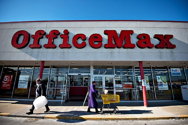 Shoppers exit an OfficeMax store in Peoria, Ill., on Wednesday. Despite early signs of slow Christmas shopping, retailers tracked by Thomson Reuters reported sales that beat analyst expectations. 