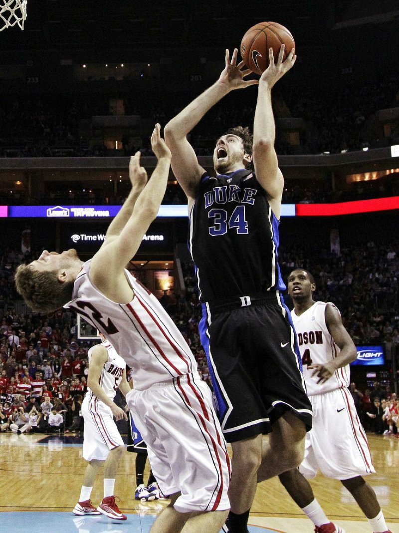 Duke's Ryan Kelly (34) shoots over Davidson's Nik Cochran (12) during the second half of an NCAA college basketball game in Charlotte, N.C., Wednesday, Jan. 2, 2013. Duke won 67-50. (AP Photo/Chuck Burton)