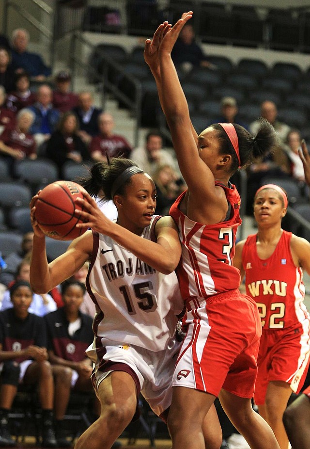 UALR forward Carolee Dillard (left) tries to make a pass as Western Kentucky’s Jalynn McClain defends during Thursday’s game at the Jack Stephens Center in Little Rock. 