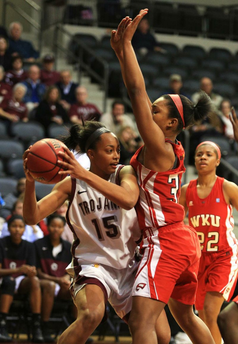 UALR forward Carolee Dillard (left) tries to make a pass as Western Kentucky’s Jalynn McClain defends during Thursday’s game at the Jack Stephens Center in Little Rock. 