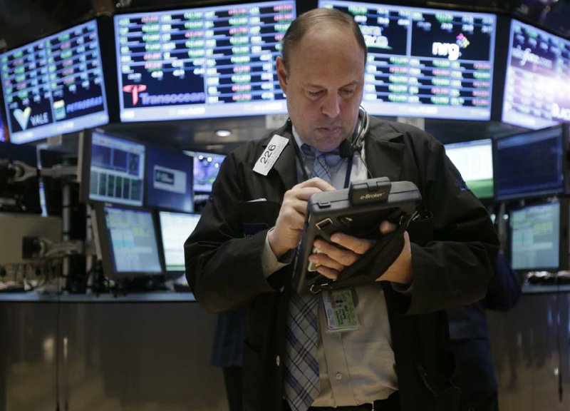 A trader works on the floor at the New York Stock Exchange in New York, Wednesday, Jan. 2, 2013.   The fiscal cliff compromise, for all its chaos and controversy, was enough to send the stock market shooting higher Wednesday, the first trading day of the new year. (AP Photo/Seth Wenig)