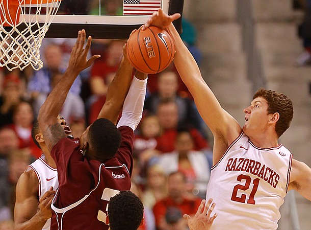 Arkansas sophomore Hunter Mickelson (21) blocks a shot during Arkansas' win over Alabama A&M at Verizon Arena in North Little Rock on Dec. 22, 2012. 