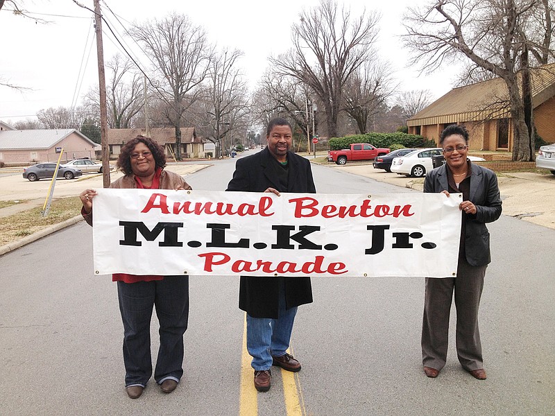 Evelyn Reed, from the left, Karl Barnes and Robin Freeman carry the banner that will be used for the MLK Parade during the Dr. Martin Luther King Jr. Holiday Celebration in Benton on Jan. 21. Reed and Freeman are organizers of the parade and other events held over four days starting Jan. 18. Barnes, president of the Ralph Bunche Neighborhood Association, will be the grand marshal of the parade.