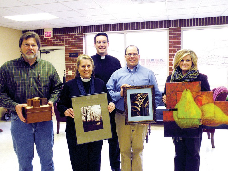 Among those planning the upcoming Art, Love, Pray fundraiser at St. Peter’s Episcopal Church are, from the left, Steve Hurd, holding some of his wooden creations that he will have in the art show; the Rev. Teri Daily, vicar at St. Peter’s, holding one of Hurd’s photographs; the Rev. Andrew Hybl, in back, curate at St. Peter’s; Chris Odom, holding one of his photographs; and Debbie Green, holding one of her paintings. 