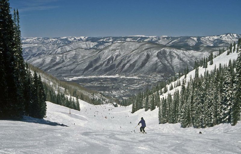 A skier enjoys the view of Roaring Fork Valley in the Aspen Ski Area. 
