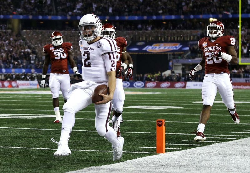 Texas A&M quarterback Johnny Manziel runs into the end zone for a touchdown during the Aggies’ 41-13 victory over Oklahoma in Friday night’s Cotton Bowl.