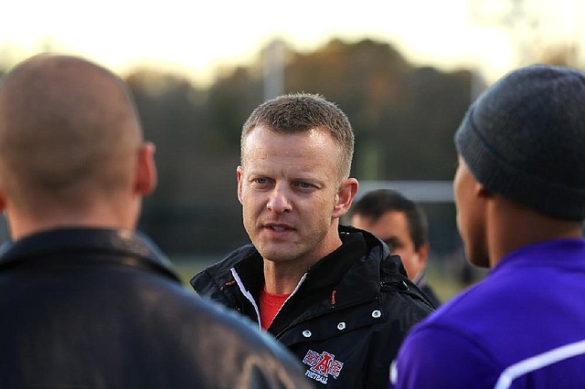 Arkansas State Coach Bryan Harsin, who is not coaching the Red Wolves in Sunday’s GoDaddy.com Bowl, talks with players during Friday’s practice in Mobile, Ala. 