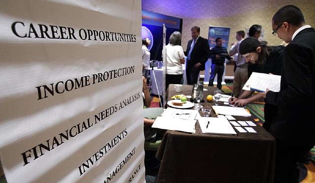 People look for work at a job fair in San Jose, Calif., in July. On Friday the U.S. government revised the unemployment rates for two months in 2012. The rate for November, first reported Dec. 7, was revised up to 7.8 percent from 7.7 percent, and the rate for July was revised down to 8.2 percent from 8.3 percent. 