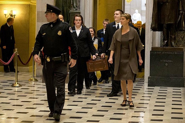 Pages lead a Senate procession Friday carrying two boxes holding Electoral College votes through Statuary Hall to the House chamber on Capitol Hill in Washington. 