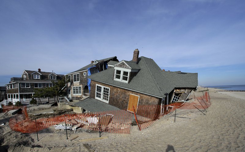 A beach front home that was severely damaged two months ago by superstorm Sandy rests in the sand in Bay Head, N.J., on Thursday, Jan. 3, 2013. 