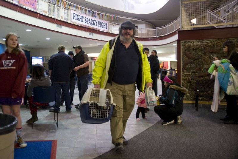 Charles Bingham heads back home with his cats after a tsunami warning was canceled early Saturday, Jan. 5, 2013, in Sitka, Alaska, following a magnitude 7.5 earthquake. 