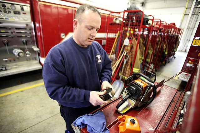 Arkansas Democrat-Gazette/RYAN MCGEENEY --01-04-2013-- Captain Jaimie Baggett of Pea Ridge conducts a brief inventory Jan. 4 of wildland firefighting tools kept inside a brush truck at Pea Ridge Volunteer Fire Department Station 1. The Arkansas Forestry Commission will be conducting an 8-hour class on wild land firefighting at the station Jan. 14-15. The Pea Ridge class is one of more than 25 sessions being taught at fire houses across the state between Jan. 5 and Aug. 6.