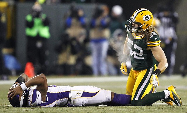 Minnesota quarterback Joe Webb reacts after throwing an incomplete pass and getting hit by Green Bay outside linebacker Clay Matthews (52) during the second half of the Vikings’ 24-10 loss to the Packers on Saturday in Green Bay, Wis. 