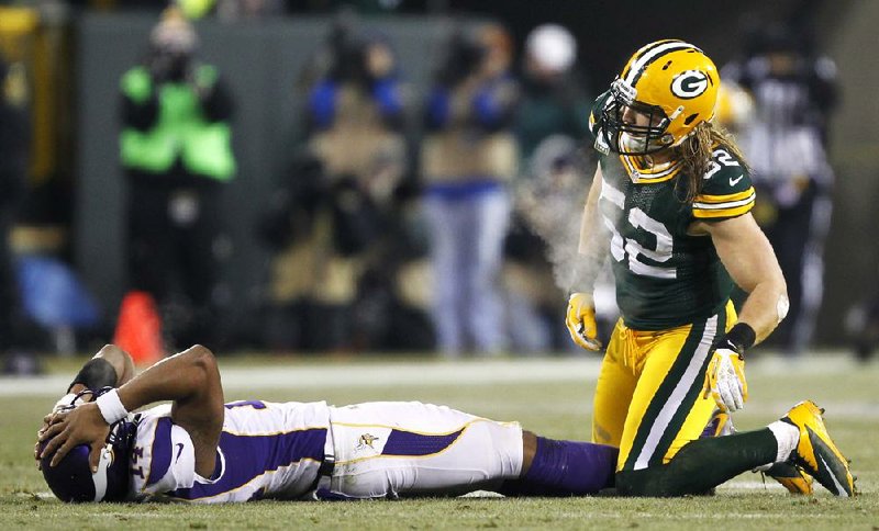 Minnesota quarterback Joe Webb reacts after throwing an incomplete pass and getting hit by Green Bay outside linebacker Clay Matthews (52) during the second half of the Vikings’ 24-10 loss to the Packers on Saturday in Green Bay, Wis. 