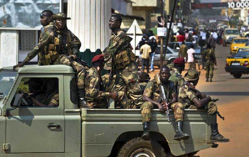 Central African Republic soldiers drive Saturday past merchant protesters in Bangui who were calling for peace between the government and rebel forces. 