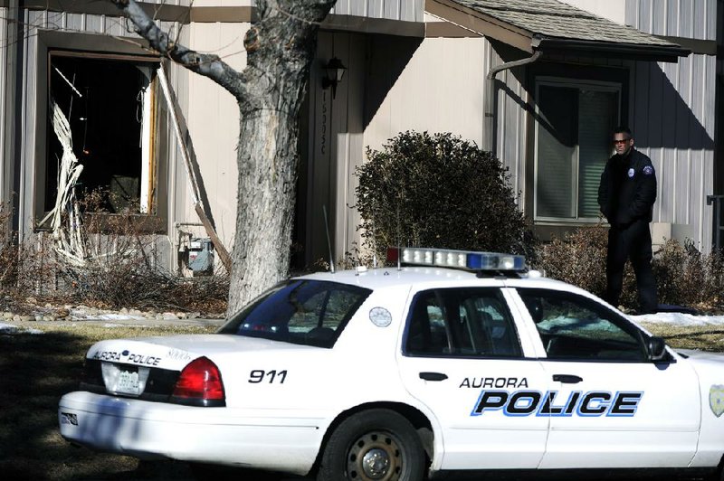 Police work Saturday outside a townhouse in Aurora, Colo., where a man had barricaded himself in and held police at bay for nearly six hours. 