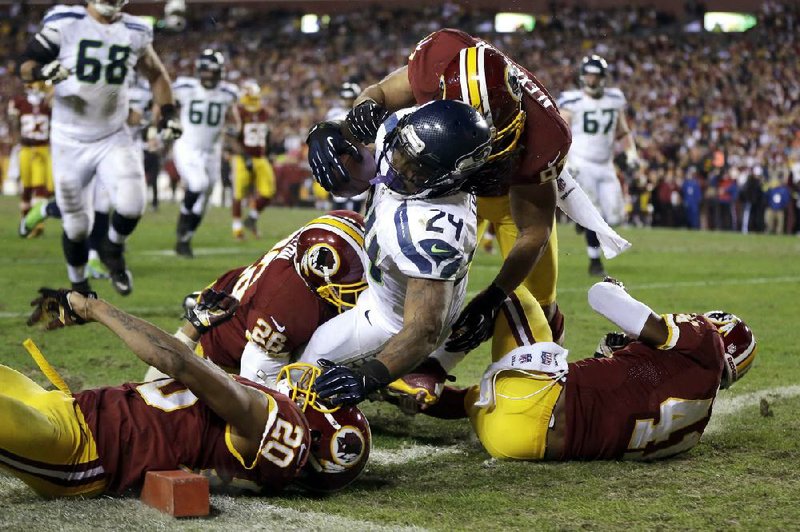 Seattle Seahawks running back Marshawn Lynch (24) tumbles into the end zone for a touchdown during the second half of Sunday’s wildcard playoff game against the Washington Redskins in Landover, Md. Lynch finished with 132 yards on 20 carries as the Seahawks defeated the Redskins 24-14. 