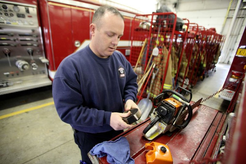 Capt. Jaimie Baggett of Pea Ridge takes inventory Friday of wildland firefighting tools kept inside a brush truck at Pea Ridge Volunteer Fire Department Station 1. The Arkansas Forestry Commission plans to hold classes on fighting wildfires at the station Jan. 14-15, part of more than 25 sessions scheduled at firehouses across the state between last week and Aug. 6. 